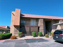 Charming condo building featuring a red tile roof and stone accents for a touch of elegance at 5321 River Glen Dr # 232, Las Vegas, NV 89103