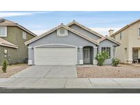 Charming single story home featuring a two car garage, desert landscaping and neutral color palette at 5820 Royal Castle Ln, Las Vegas, NV 89130