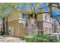 Beautiful two-story condo featuring a stone facade and private balcony at 701 Peachy Canyon Cir # 201, Las Vegas, NV 89144
