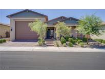 Charming single story home features a well maintained lawn, desert landscaping, and an attached two car garage at 709 Corelli Cove St, Henderson, NV 89011