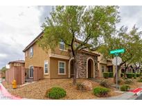 Inviting two-story home featuring a stone-accented entrance and low-maintenance landscaping at 9925 Turquoise Glass Ct, Las Vegas, NV 89178