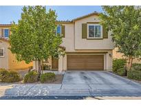 Two-story home with a two car garage and desert landscaping at 10931 Sardinia Sands Dr, Las Vegas, NV 89141