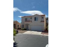 Two-story home featuring a tile roof, stucco exterior, and an attached two-car garage at 1153 Stormy Valley Rd, Las Vegas, NV 89123