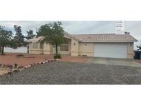Charming single-story home with a two-car garage and low maintenance desert landscaping at 2431 S Dandelion St, Pahrump, NV 89048