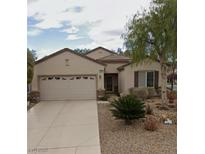 Charming single-story home with a two-car garage and desert landscaping in front yard at 2560 Crater Rock St, Henderson, NV 89044