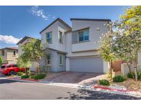 Charming two-story home featuring a two-car garage, neat landscaping, and a welcoming facade at 28 Verde Rosa Dr, Henderson, NV 89011