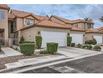Charming townhome with a two-car garage and manicured landscaping at 3111 Lido Isle Ct, Las Vegas, NV 89117