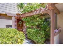 Charming home entrance with a brick facade and a decorative wreath on the door at 3249 Dayflower St # C, Las Vegas, NV 89121