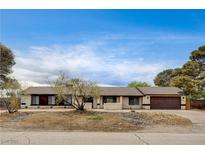 Charming single story home featuring desert landscaping and a two car garage at 3575 W Robindale Rd, Las Vegas, NV 89139