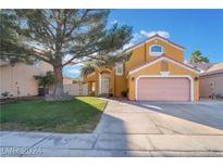 Charming two-story home featuring a well-manicured lawn, mature tree, and a two-car garage, creating a welcoming curb appeal at 4209 Glass Lantern Dr, North Las Vegas, NV 89032