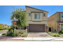 Inviting two-story home with desert landscaping, paver driveway, and a two-car garage in a modern community at 4503 Meteora Ledge Ave, North Las Vegas, NV 89084