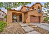 Charming two-story home showcasing a private front porch, two-car garage and desert landscaping at 617 Apricot Rose Pl, Las Vegas, NV 89138