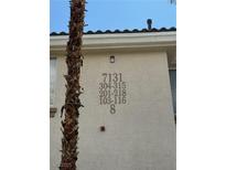 Condominium complex exterior with multiple units indicated by numbering near the entry at 7131 S Durango Dr # 104, Las Vegas, NV 89113