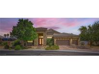 Charming single-Gathering home displaying beautiful desert landscaping and a three-car garage at 7418 Lawrence Powers Ct, Las Vegas, NV 89129
