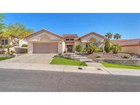 Inviting single-story home with manicured landscaping, tile roof, and spacious two-car garage at 9916 Netherton Dr, Las Vegas, NV 89134