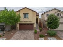 Charming two-story home featuring a neat brick driveway and a well-maintained landscaped front yard at 10617 Hartford Hills Ave, Las Vegas, NV 89166