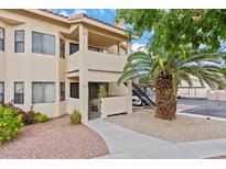 Inviting condo exterior with a well-maintained yard and a quaint front patio area at 1112 Observation Dr # 201, Las Vegas, NV 89128