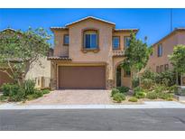 Charming two-story home featuring a two-car garage, stone accents, and professionally landscaped front yard at 12546 Mosticone Way, Las Vegas, NV 89141