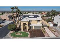 Beautiful two-story home featuring solar panels, a two-car garage, desert landscaping and an expansive city view at 1407 Fields St, Las Vegas, NV 89142