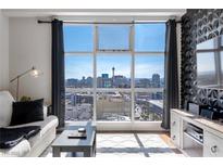 Bright living room featuring large windows with city views, hardwood floors, and modern decor at 150 Las Vegas Blvd # 1608, Las Vegas, NV 89101