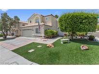 Charming two-story home featuring a landscaped front yard, garage, and inviting curb appeal at 2112 Preakness Pass, Las Vegas, NV 89117