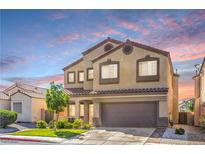 Inviting two-story home features a neutral color scheme, tile roof, and low-maintenance landscaping at 2496 Citrus Garden Cir, Henderson, NV 89052