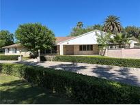 Charming single-story home features a stone exterior, manicured landscaping, and a private driveway at 250 Rancho Cir, Las Vegas, NV 89107
