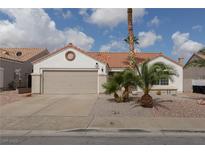 Charming single-story home featuring a two-car garage, desert landscaping, and a classic terra cotta roof at 517 Scenic Terra Dr, Henderson, NV 89015