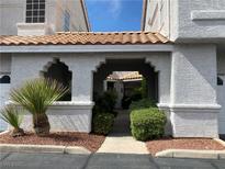 Attractive townhome exterior featuring landscaped grounds and covered entryway at 5201 S Torrey Pines Dr # 1253, Las Vegas, NV 89118