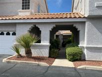 Inviting courtyard entrance with lush landscaping and tile roof at 5201 S Torrey Pines Dr # 1253, Las Vegas, NV 89118