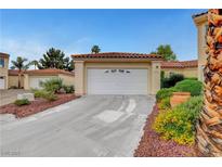 Charming single-story home featuring a two-car garage, tile roof, and attractive landscaping at 5373 Painted Mirage Rd, Las Vegas, NV 89149