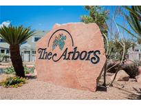 A large stone sign for The Arbors community, surrounded by desert landscaping and blue skies at 5516 Orchard Ln # 0, Las Vegas, NV 89110