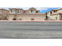 Well-maintained condo building with multiple garages and neutral color scheme at 6635 Flaminian Ln # 104, North Las Vegas, NV 89084