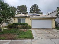 Charming single-story home with a two-car garage, desert landscaping, and solar panels on the roof at 7617 Sea Cliff Way, Las Vegas, NV 89128