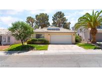 Charming single-story home features a well-manicured lawn and a two-car garage at 7617 Sea Cliff Way, Las Vegas, NV 89128
