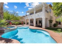 Inviting backyard with a pool and a beautiful two-story house at 820 Colina Alta Pl, Las Vegas, NV 89138