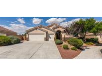 Charming single story home with a three car garage, desert landscaping, and a tile roof under sunny blue skies at 8204 Turbys Treehouse Pl, Las Vegas, NV 89131