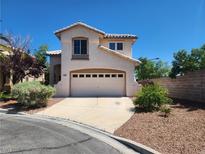 Charming two-story home with a two-car garage and well-maintained landscaping at 10400 Beachwalk Pl, Las Vegas, NV 89144