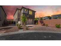 Contemporary two-story home boasting desert landscaping, brick accents, and a brick driveway at 10793 Pastel Sunset Ct, Las Vegas, NV 89135