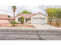 Charming single-story home features a well-maintained yard and attached two car garage at 1220 Basin Brook Dr, North Las Vegas, NV 89032