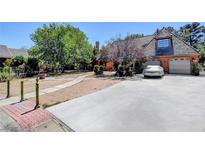 Charming two-story home with well-manicured landscaping and a spacious driveway leading to a two-car garage at 1700 Red Rock St, Las Vegas, NV 89146