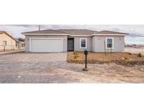 Charming single-story home with a two-car garage and desert landscaping at 2071 Idaho St, Pahrump, NV 89048