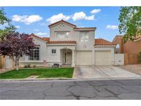 Charming two-story home features a terracotta roof, stucco facade, and a well-manicured front yard at 2124 Rising Mist St, Las Vegas, NV 89134