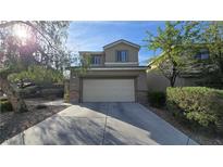 Charming two-story home featuring a two-car garage and inviting curb appeal with mature landscaping at 2737 Rimbaud St, Henderson, NV 89044