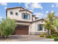Charming two-story home with a two-car garage and well-maintained landscaping, enhanced by a beautiful blue sky at 3218 Mura Del Prato Ave, Henderson, NV 89044