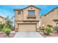 Charming two-story home featuring a well-maintained exterior, attached garage, and landscaping at 3448 Quiet Pueblo St, North Las Vegas, NV 89032