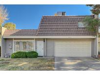 Charming townhome featuring a two-car garage, secure front door, and verdant landscaping, situated on a sunny day at 3642 Haverhill St, Las Vegas, NV 89121