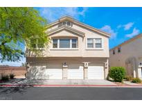 Inviting townhome featuring a three-car garage and neutral stucco exterior, perfect for modern living at 4608 Snake Eyes St # 102, Las Vegas, NV 89122