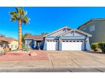 Charming single-story home with a well-manicured lawn, palm tree, and a two-car garage at 52 Vallejo Verde St, Henderson, NV 89012
