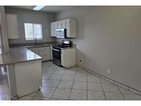 Functional kitchen featuring white cabinets and modern appliances at 5655 E Sahara Ave # 2020, Las Vegas, NV 89142